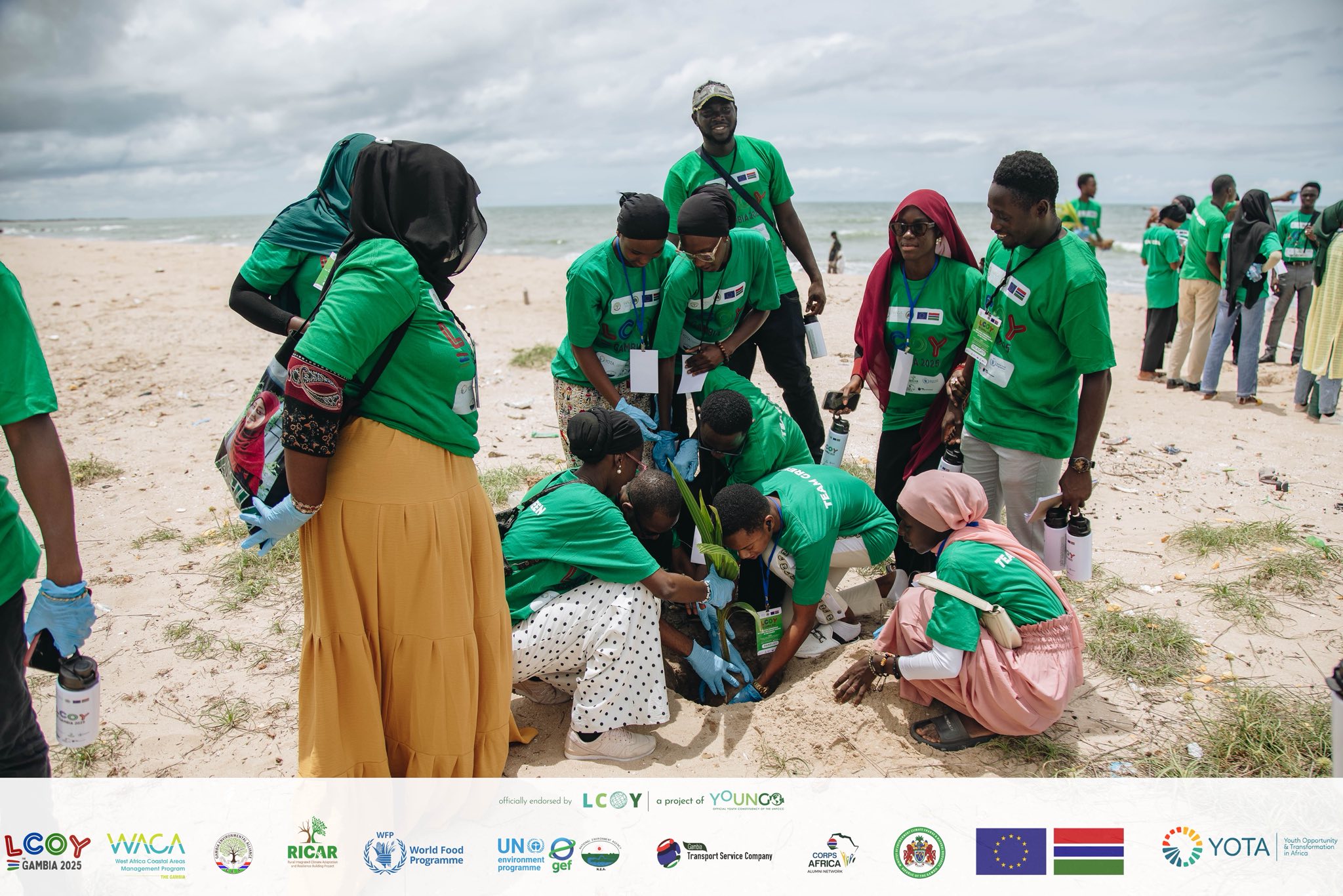 Youth delegates engaged in coastal coconut tree planting.